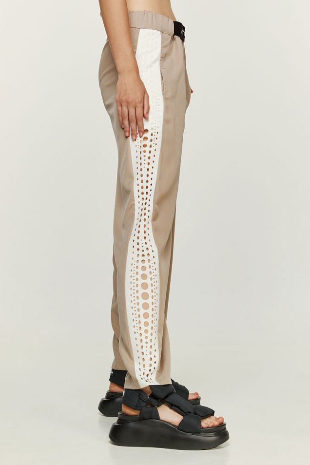 Pants embellished with laser cut designs