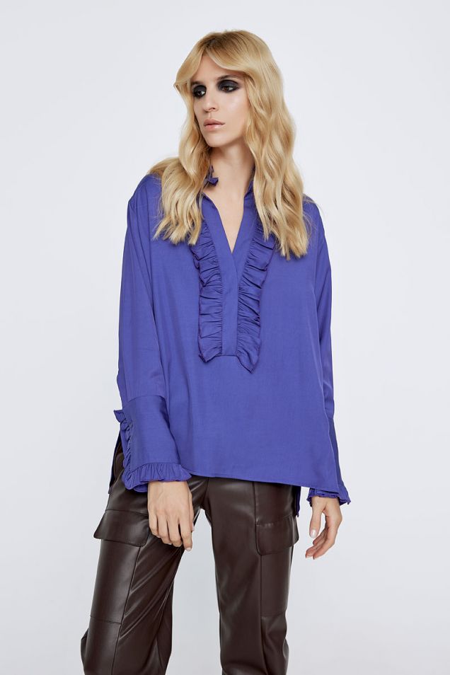 Purple blouse embellished with ruffles. 