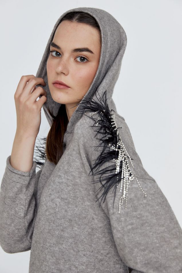 Stretchy hooded blouse with  feather and rhinestone details 
