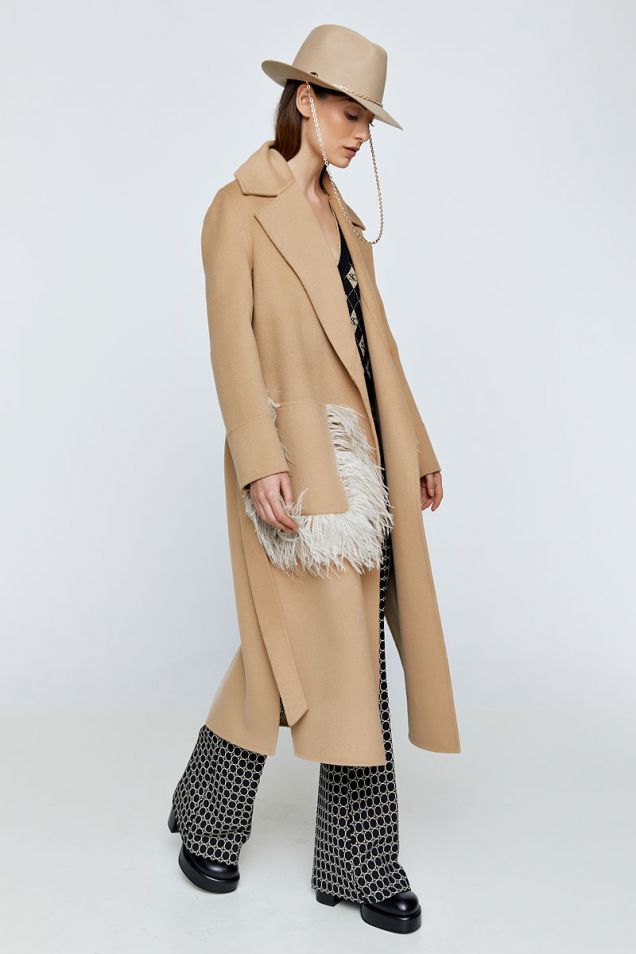 Coat in beige embellished with feathers