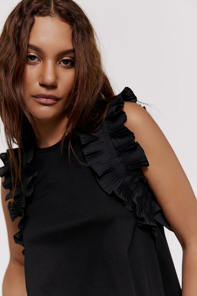 Black top embellished with ruffles 